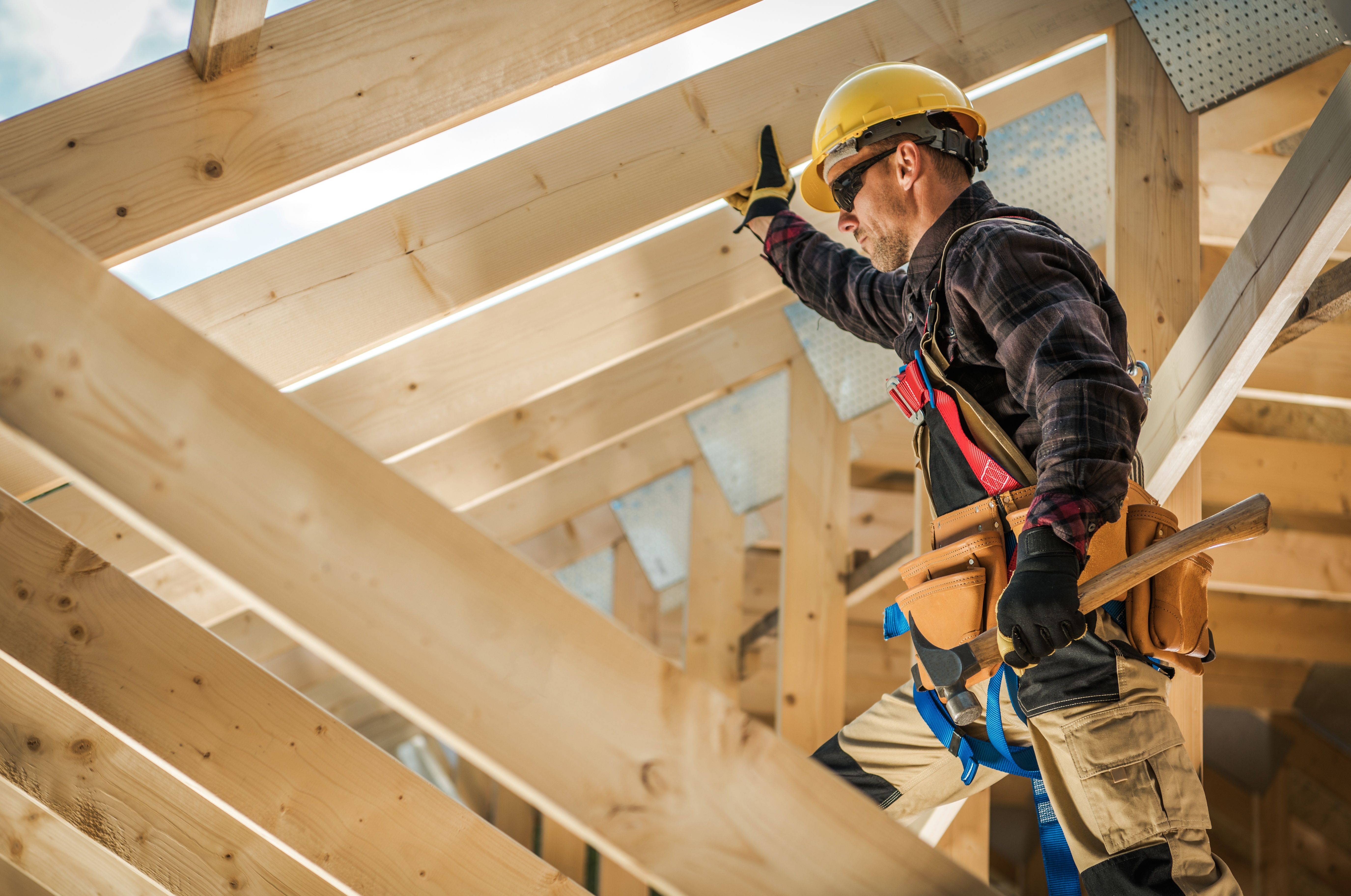 Worker framing a roof